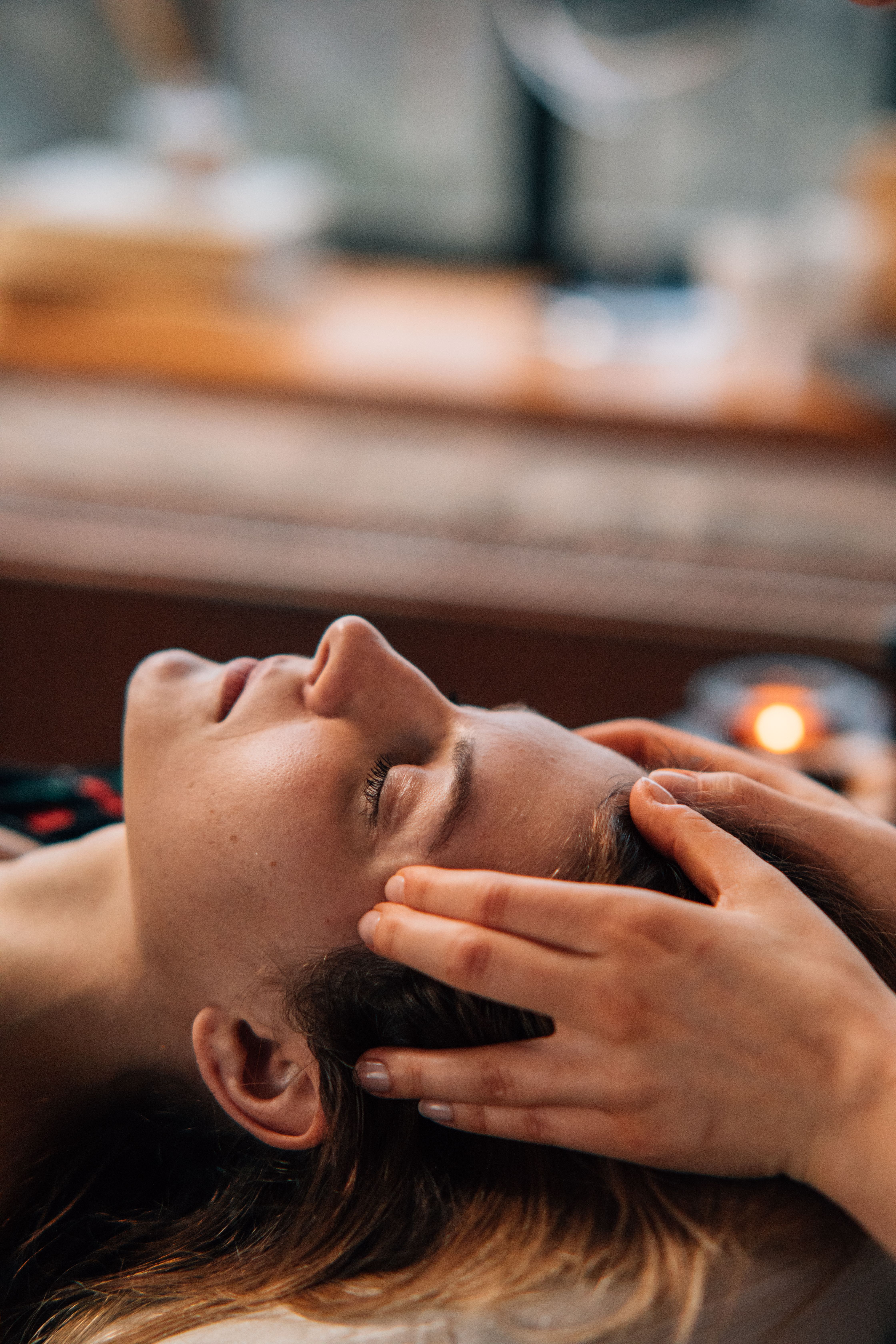 An image of a woman receiving a head massage